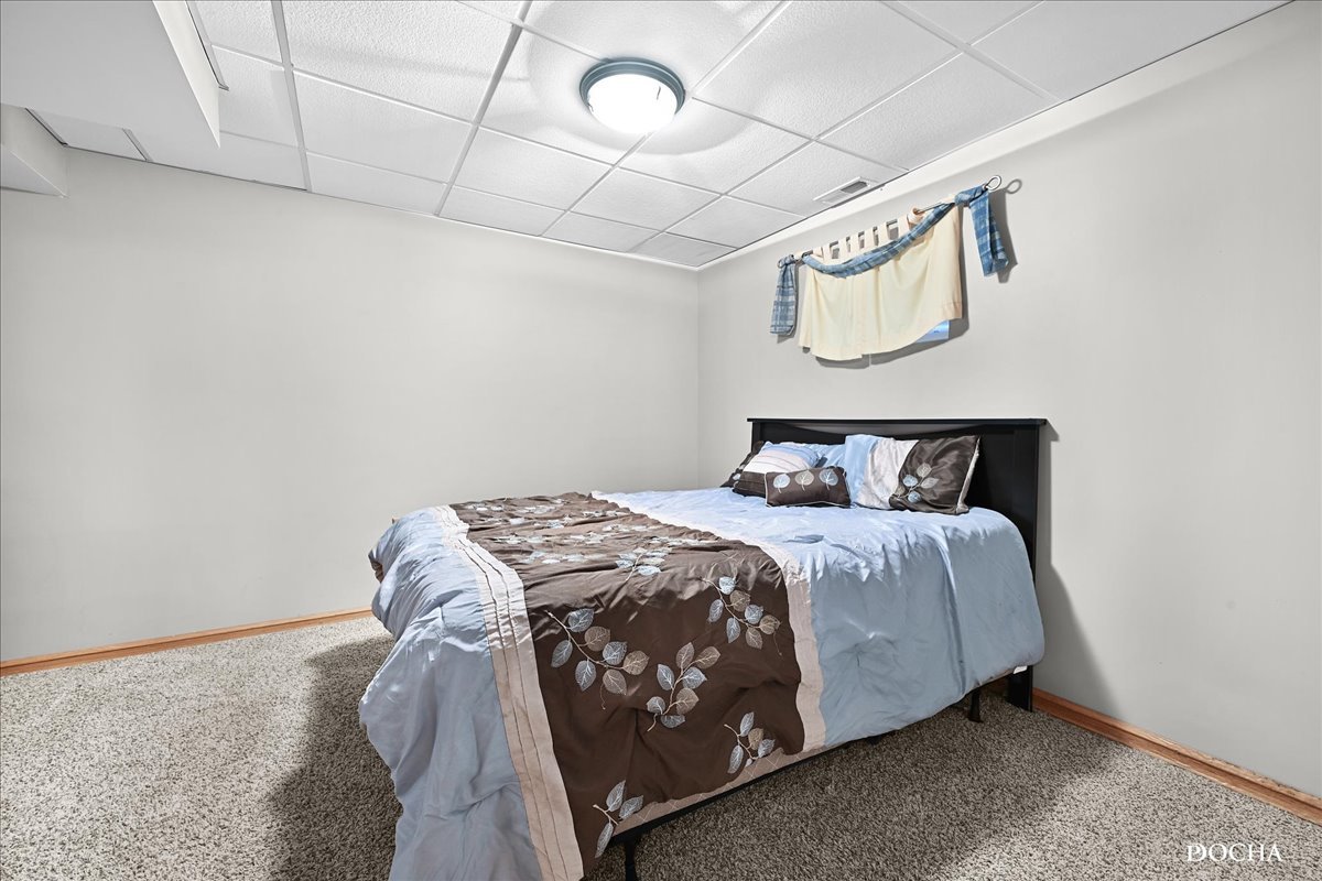 2209 Gray Hawk Drive Plainfield, IL 60586 - Photo 31 of 51 a bedroom with a bed and a table