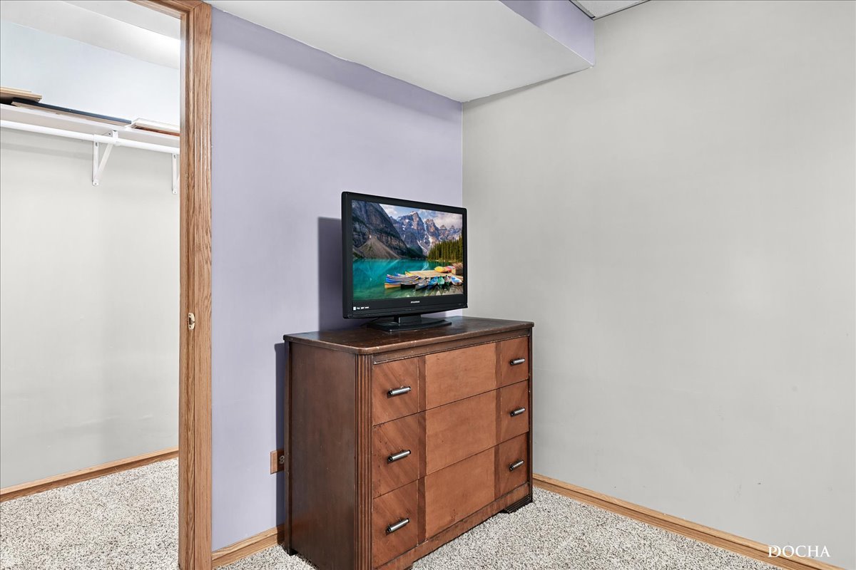 2209 Gray Hawk Drive Plainfield, IL 60586 - Photo 32 of 51 a living room with furniture and a flat screen tv