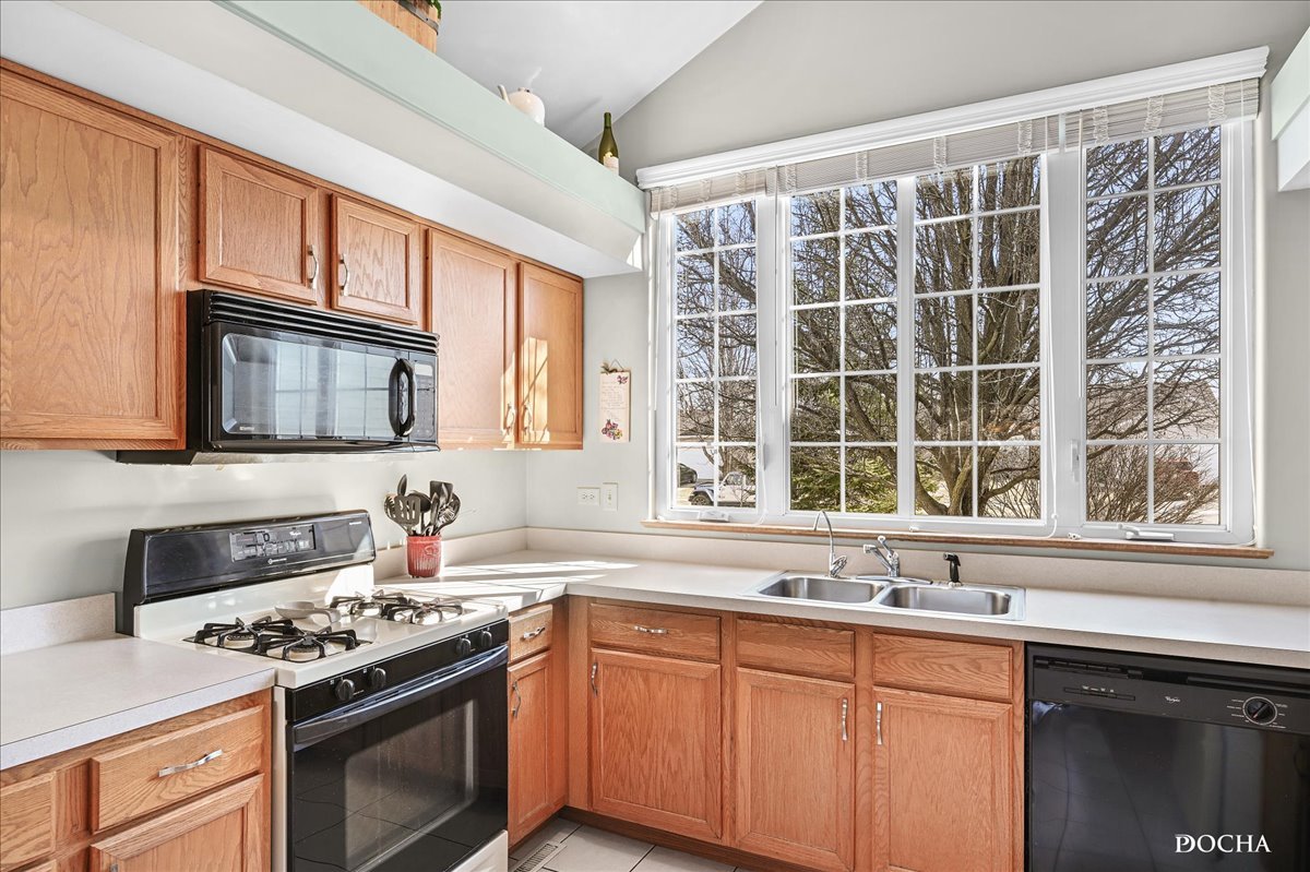 2209 Gray Hawk Drive Plainfield, IL 60586 - Photo 5 of 51 a kitchen with stainless steel appliances granite countertop a sink stove and cabinets
