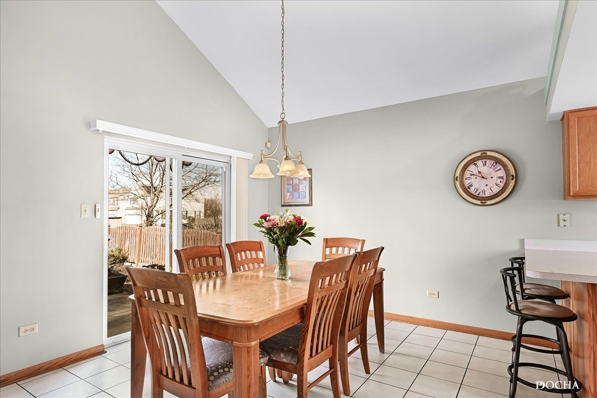 2209 Gray Hawk Drive Plainfield, IL 60586 - Photo 8 of 51 a view of a dining room with furniture and a chandelier