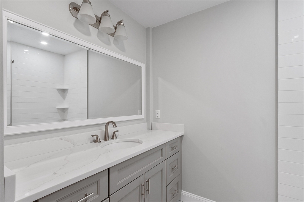 10 Windsor Street, Unit C Worcester, MA 01605 - Photo 16 of 31 a bathroom with a sink and a mirror