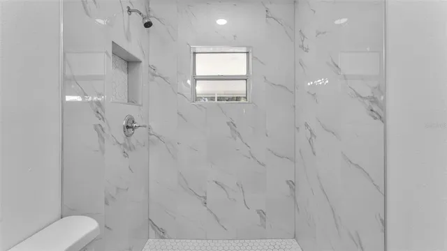 a bathroom with a shower and toilet