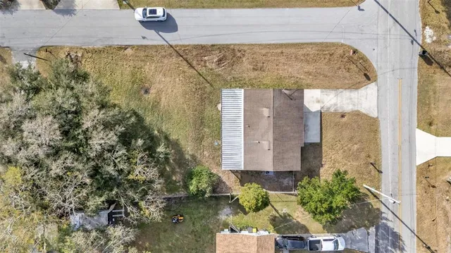 a aerial view of a house with a yard