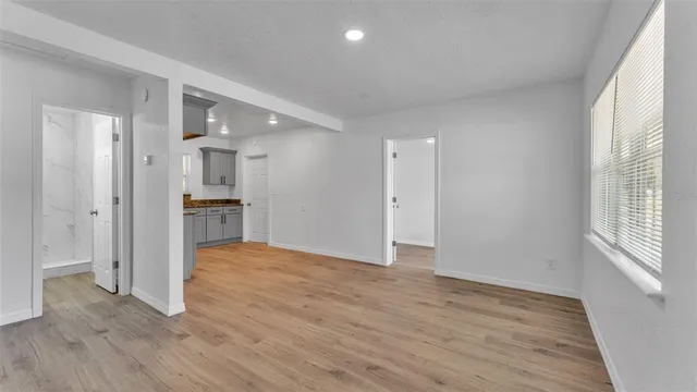 a view of empty room with wooden floor