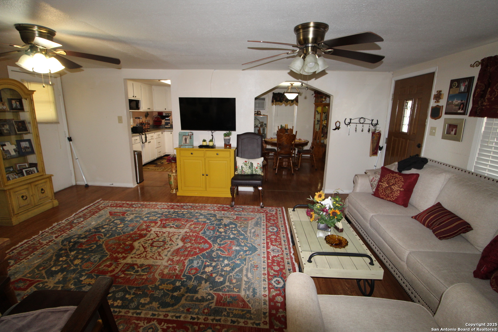 19411 South Somerset Street Lytle, TX 78052 - Photo 11 of 27 a bedroom with a bed a flat screen tv and a chandelier