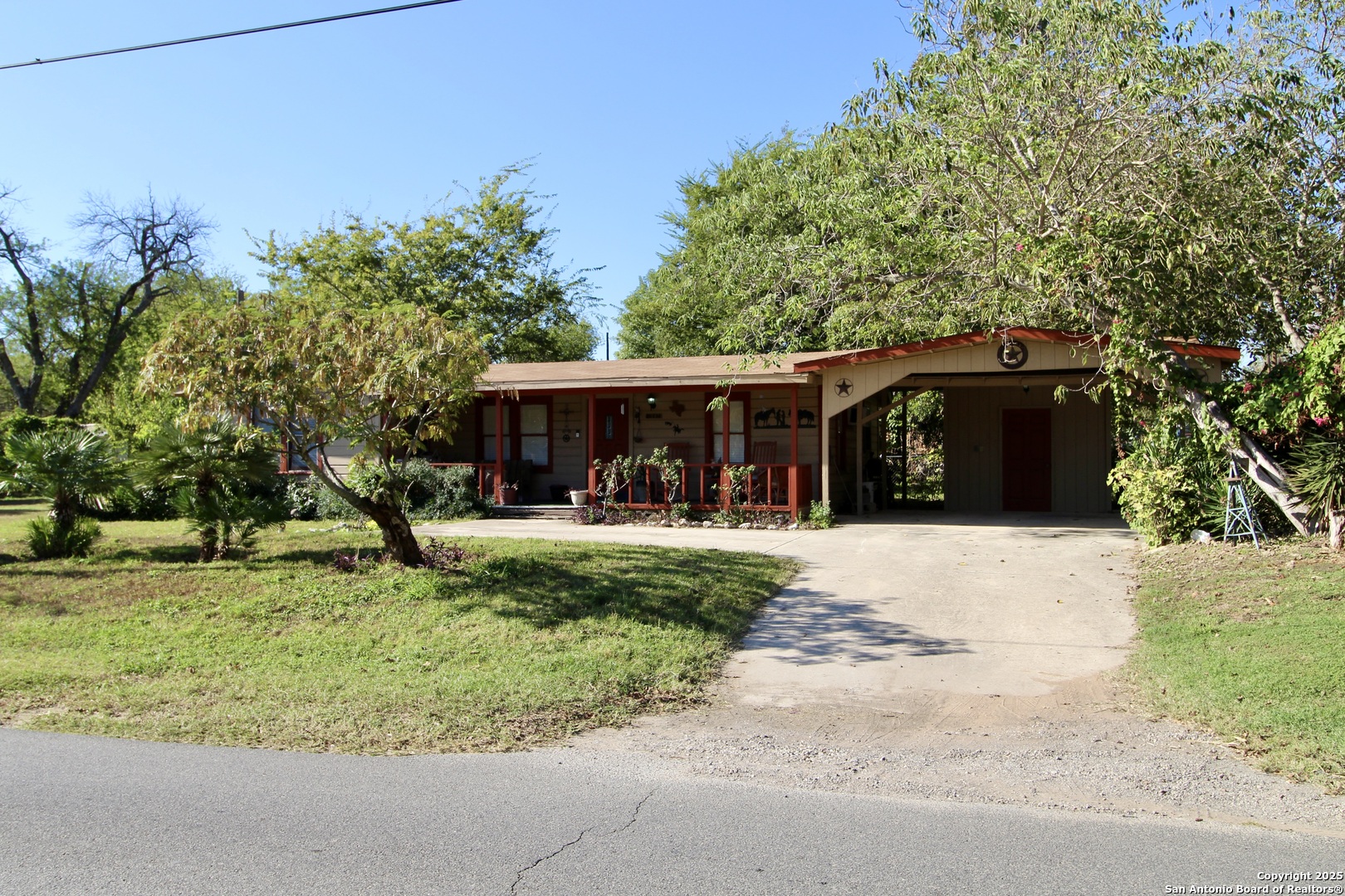 19411 South Somerset Street Lytle, TX 78052 - Photo 2 of 27 a front view of a house with garden