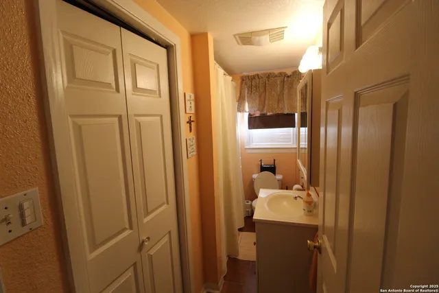 a bathroom with a shower and a sink