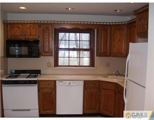 29 Morganville Road Old Bridge, NJ 07747 - Photo 5 of 9 a kitchen with stainless steel appliances granite countertop a stove a sink and a refrigerator