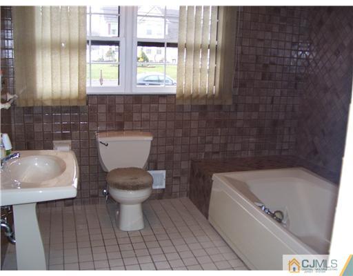 29 Morganville Road Old Bridge, NJ 07747 - Photo 7 of 9 a bathroom with a sink a toilet and bathtub