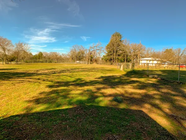 a view of a field with an ocean view