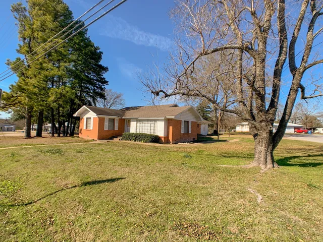 a front view of a house with a yard
