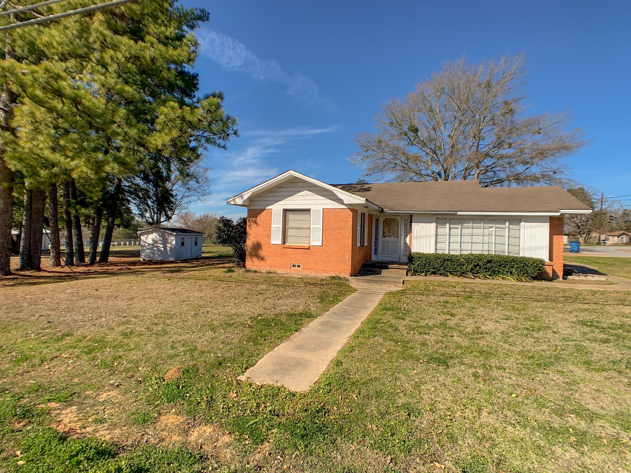 519 West Commerce Street Buffalo, TX 75831 - Photo 5 of 28 a front view of a house with a garden