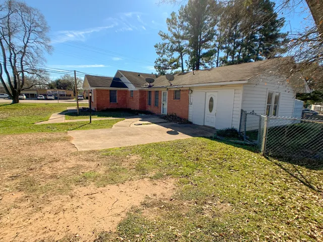 a view of house with backyard