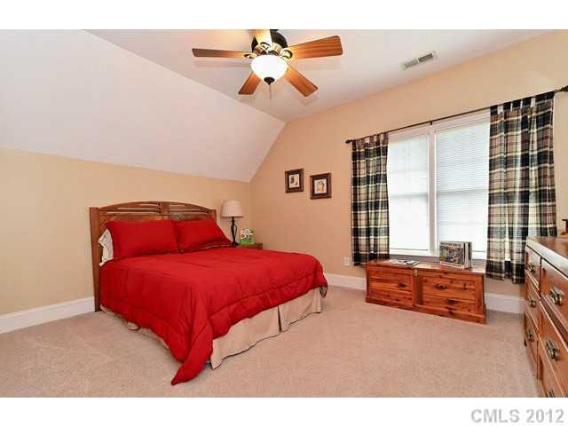 550 Cranborne Chase Fort Mill, SC 29708 - Photo 13 of 16 a bedroom with a large bed and a chandelier