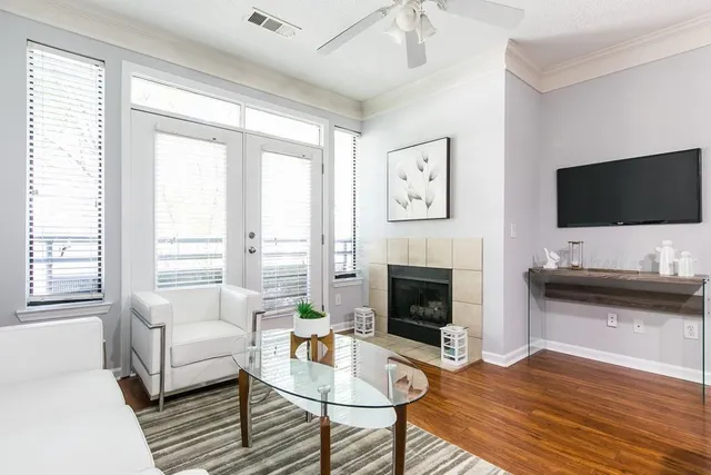 a living room with furniture a fireplace and a flat screen tv