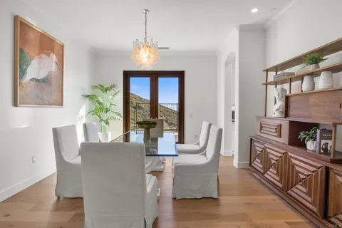 a dining room with furniture a fireplace and wooden floor