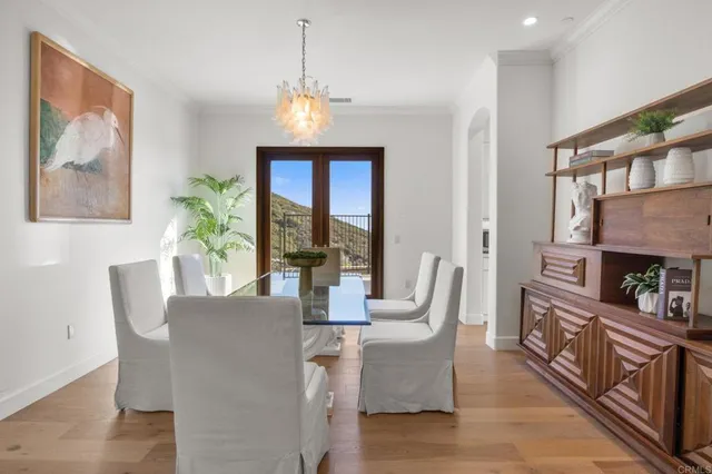a dining room with furniture a fireplace and wooden floor