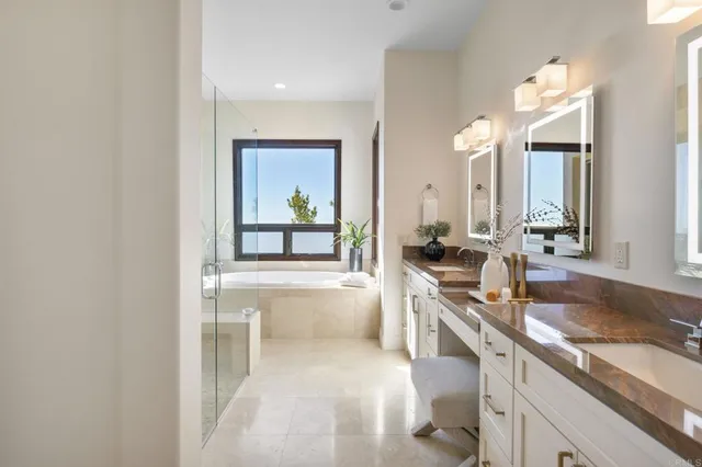 a large white kitchen with a sink and dishwasher a stove with wooden floor