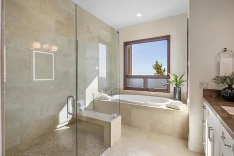 a spacious bathroom with a tub and sink