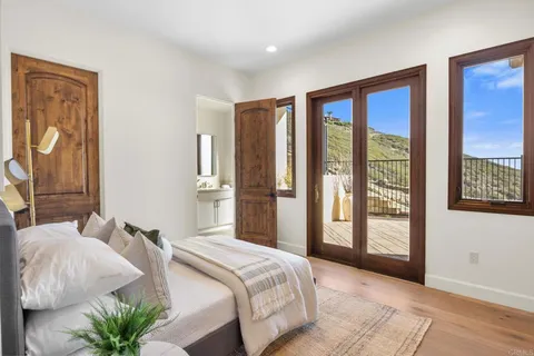 a bedroom with a large bed and a large window