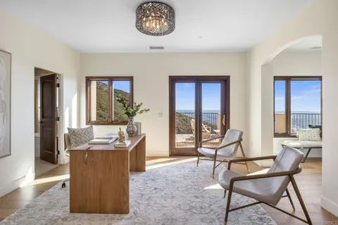 a view of a livingroom with furniture and a dining table