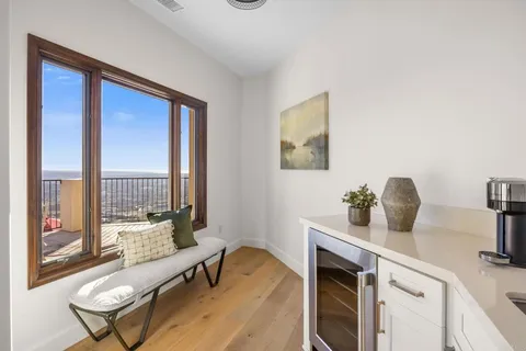 a living room with furniture and a floor to ceiling window