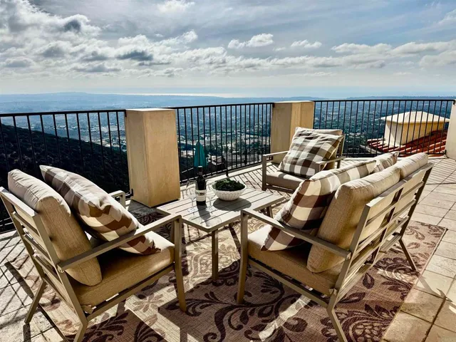 a view of a house with swimming pool and sitting area