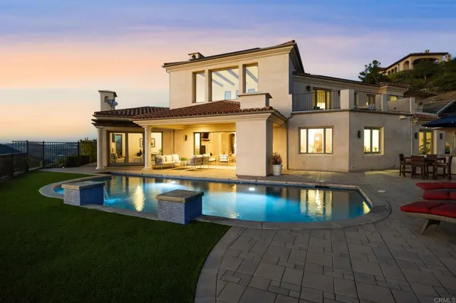 a front view of a house with swimming pool having outdoor seating