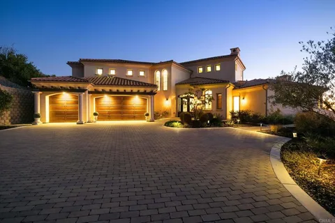 a view of a house with a swimming pool and a yard