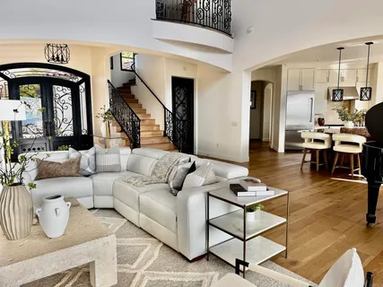 a living room with furniture and wooden floor