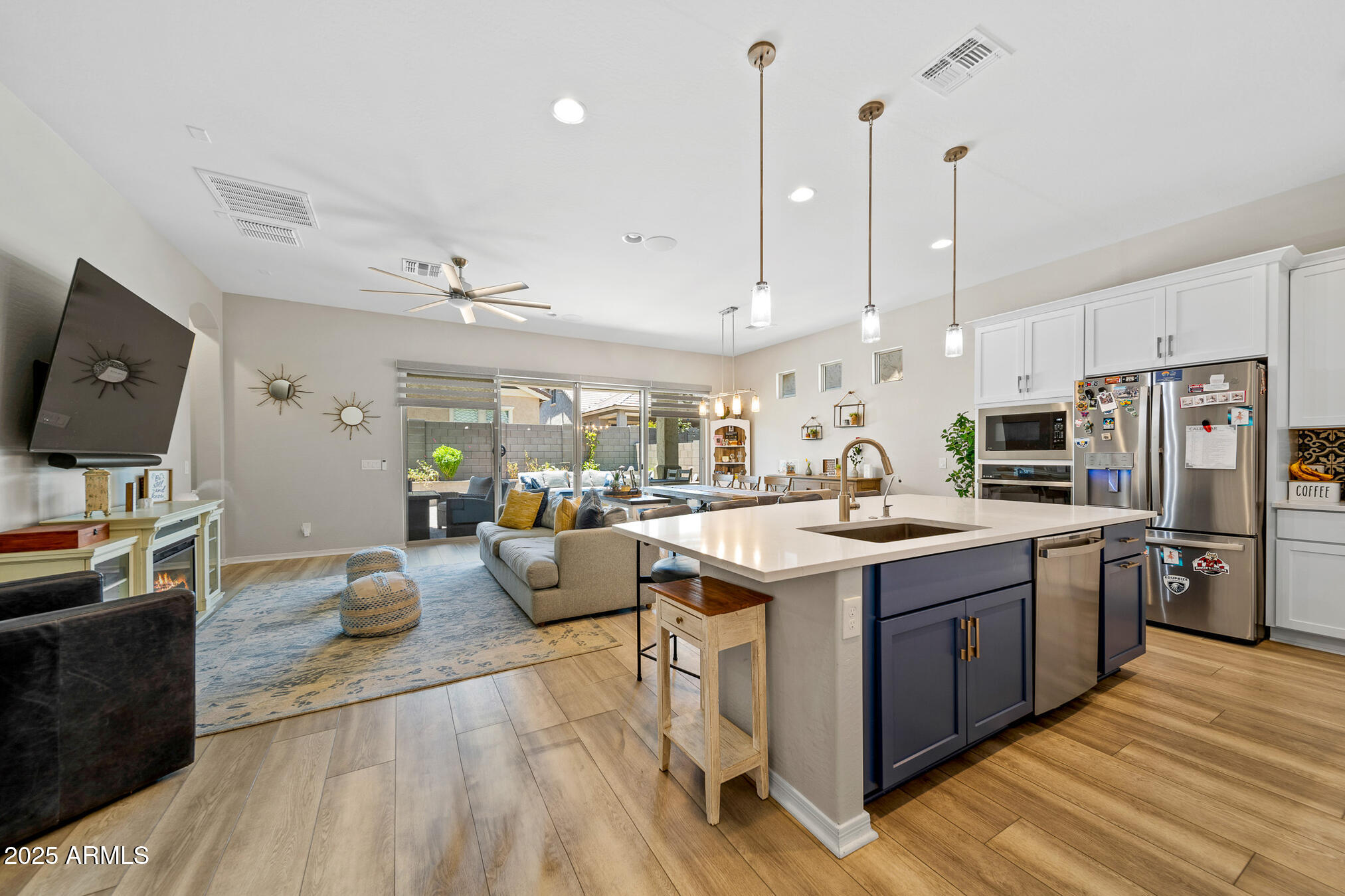 4155 East Jesse Street Gilbert, AZ 85295 - Photo 13 of 71 a large kitchen with stainless steel appliances kitchen island granite countertop a large kitchen island and a view of living room