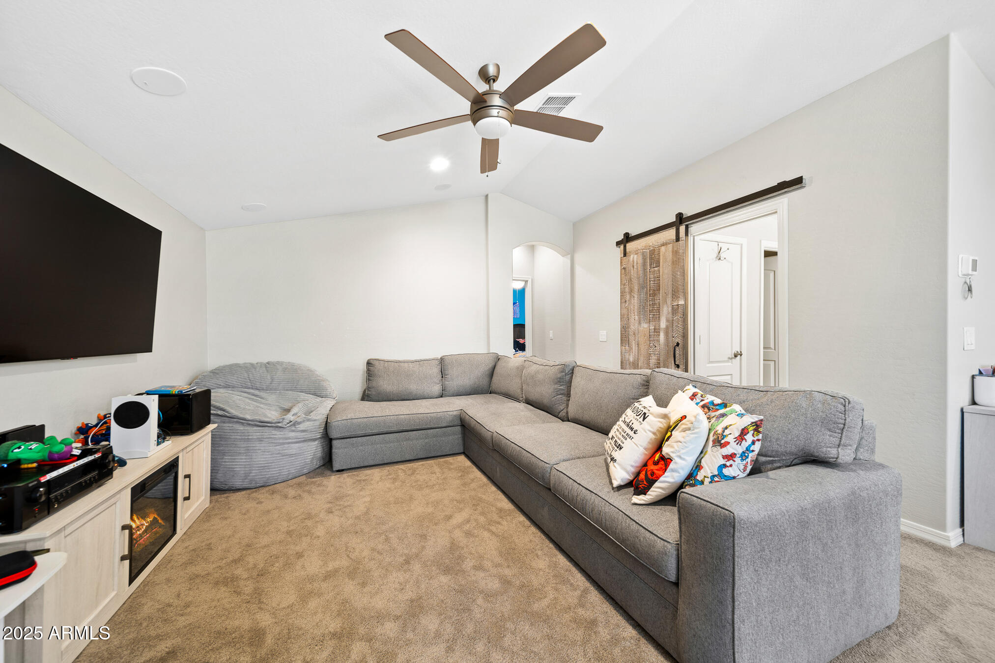 4155 East Jesse Street Gilbert, AZ 85295 - Photo 34 of 71 a living room with furniture and a flat screen tv