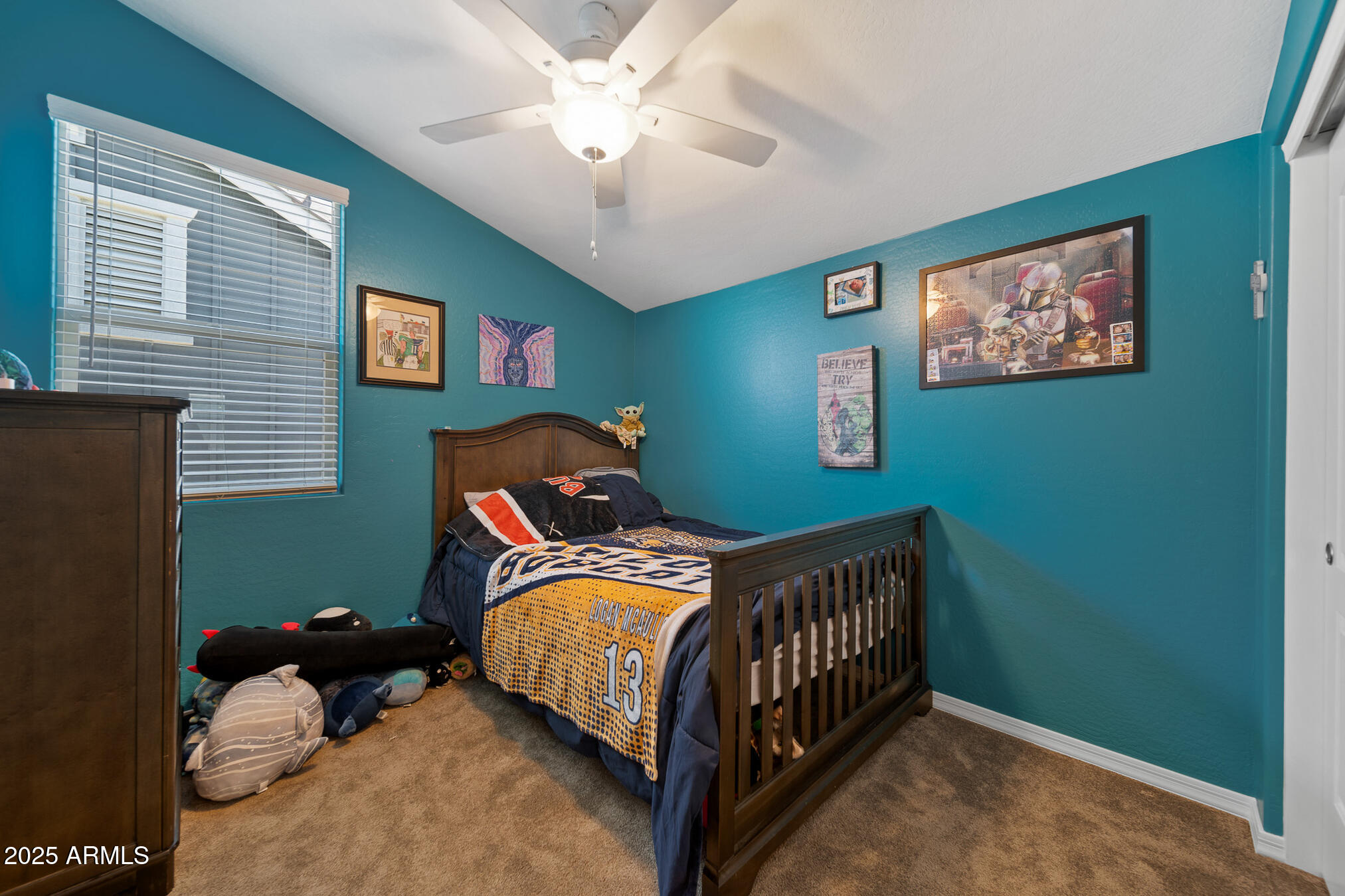 4155 East Jesse Street Gilbert, AZ 85295 - Photo 40 of 71 a bedroom with a bed and a chandelier