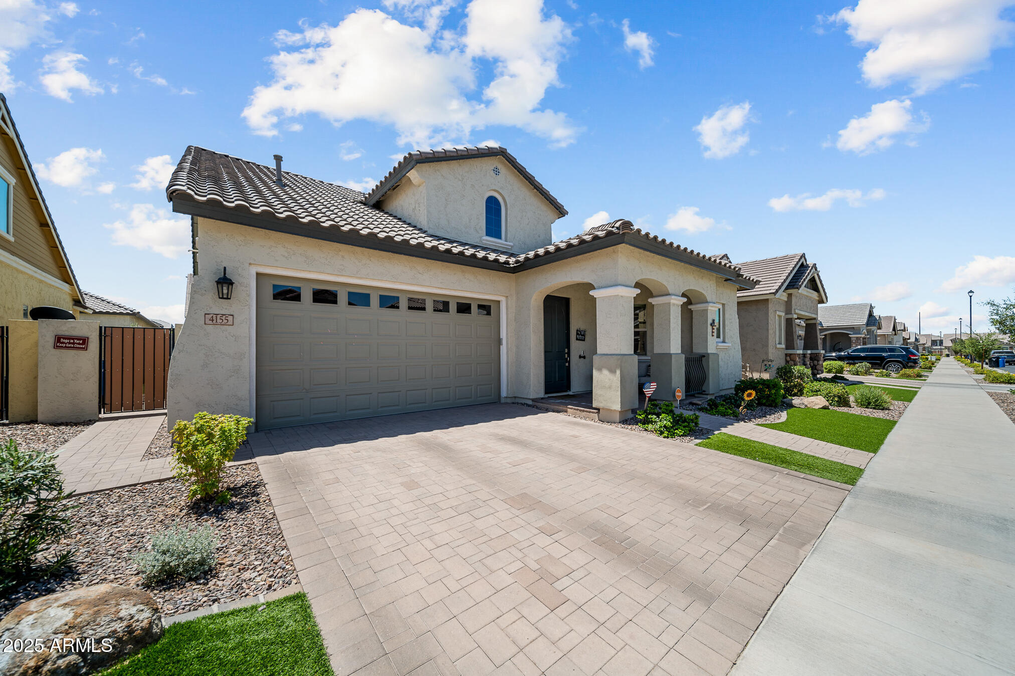 4155 East Jesse Street Gilbert, AZ 85295 - Photo 7 of 71 a front view of a house with a yard and potted plants