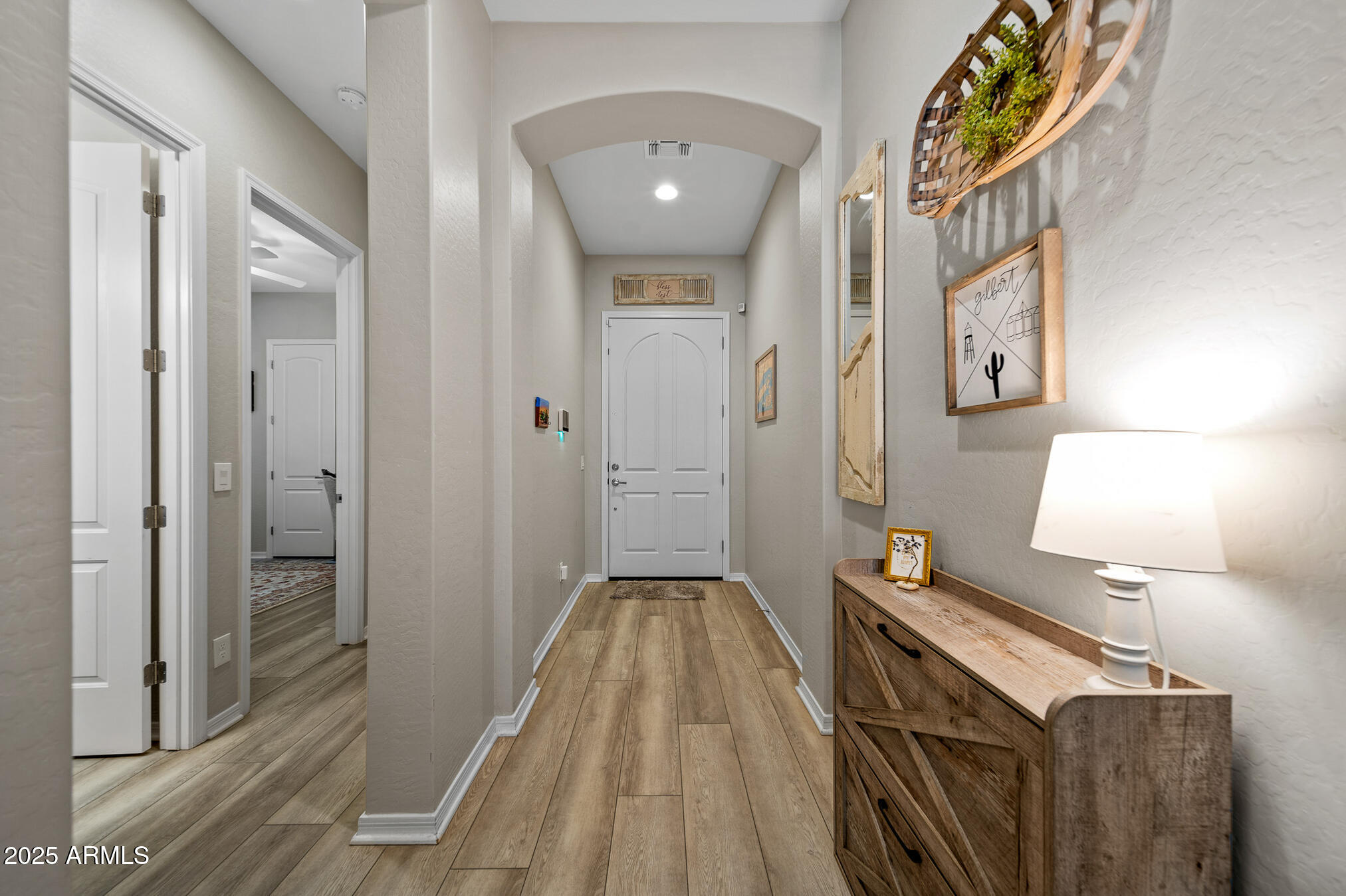 4155 East Jesse Street Gilbert, AZ 85295 - Photo 10 of 71 a view of a hallway with wooden floor and staircase