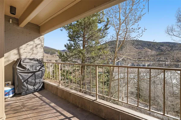 a view of balcony with wooden floor and fence