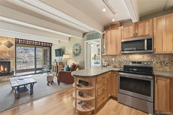 a kitchen with a stove a sink and a microwave