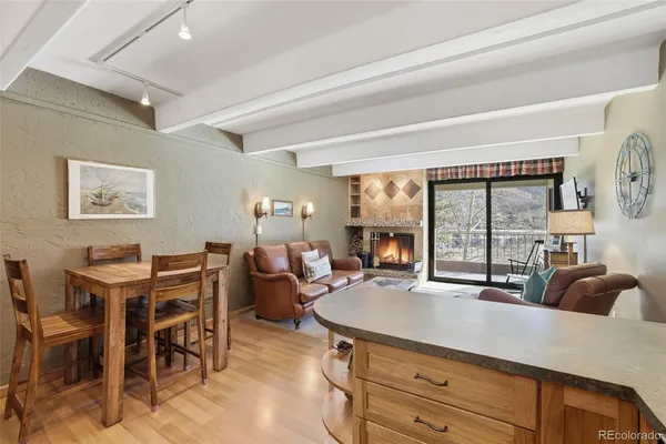 a living room with furniture a large window and a table