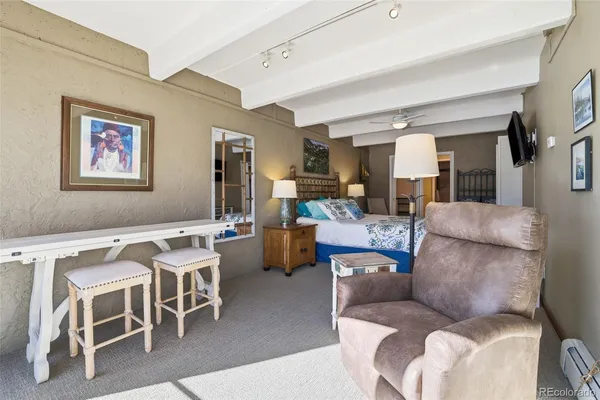 a living room with furniture and a dining table