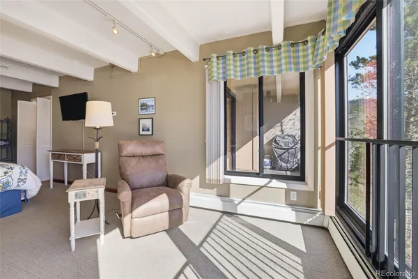 a living room with furniture and a floor to ceiling window