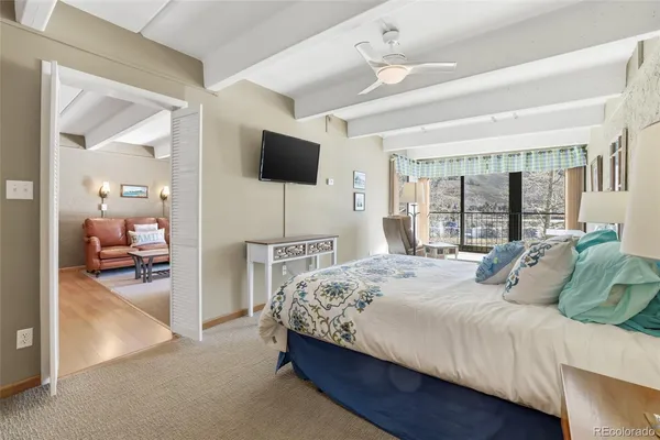 a bedroom with a large bed and a large mirror