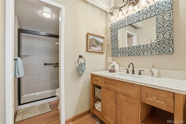 a bathroom with a granite countertop sink mirror and shower