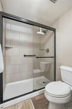 a bathroom with a toilet and a shower