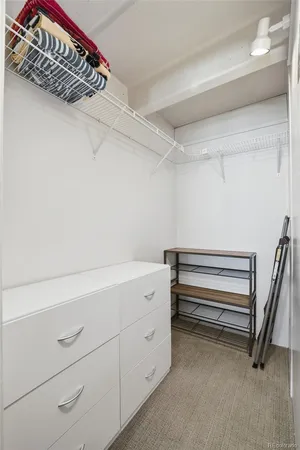 a view of walk in closet with empty racks