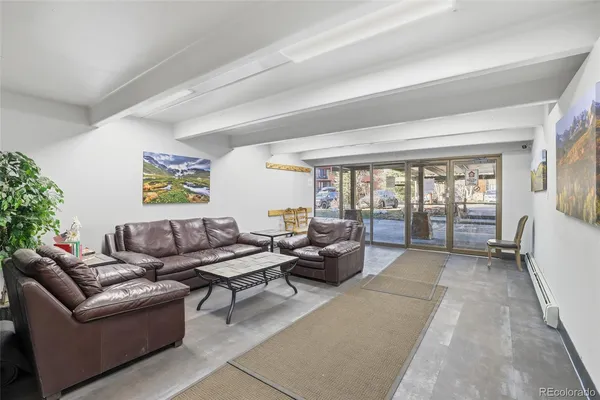 a living room with furniture and a floor to ceiling window