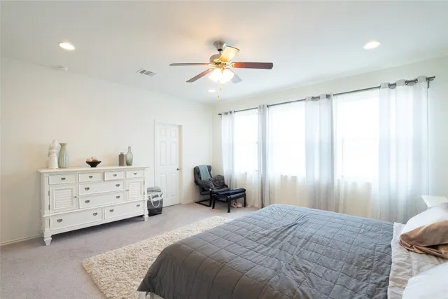 a bedroom with a bed and a dresser