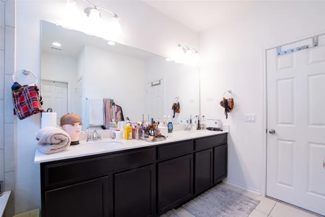 a bathroom with a sink vanity and mirror