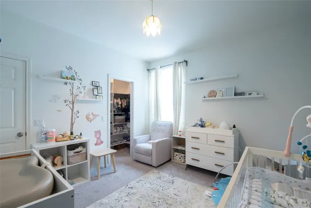 a bedroom with furniture and a chandelier