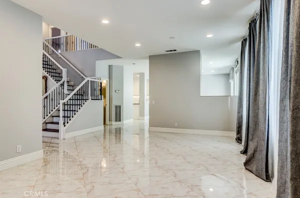 a view of a big room with entryway and wooden floor