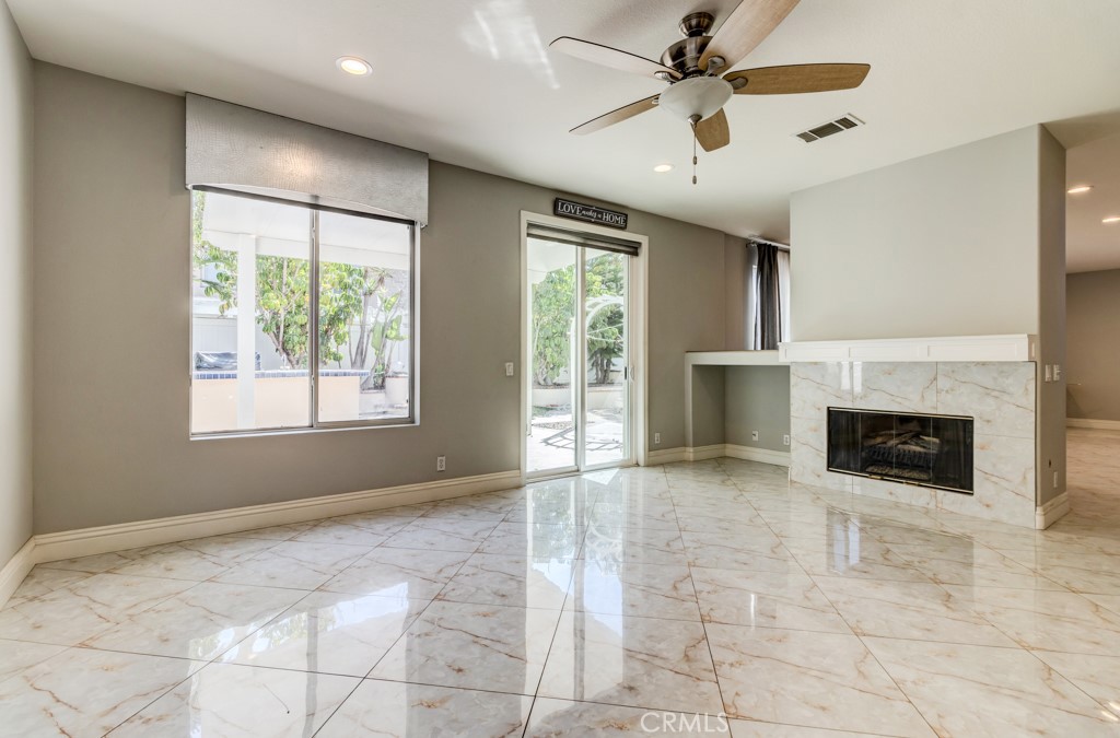 8 Zinnia Irvine, CA 92618 - Photo 16 of 63 a view of an empty room with a fireplace and a window